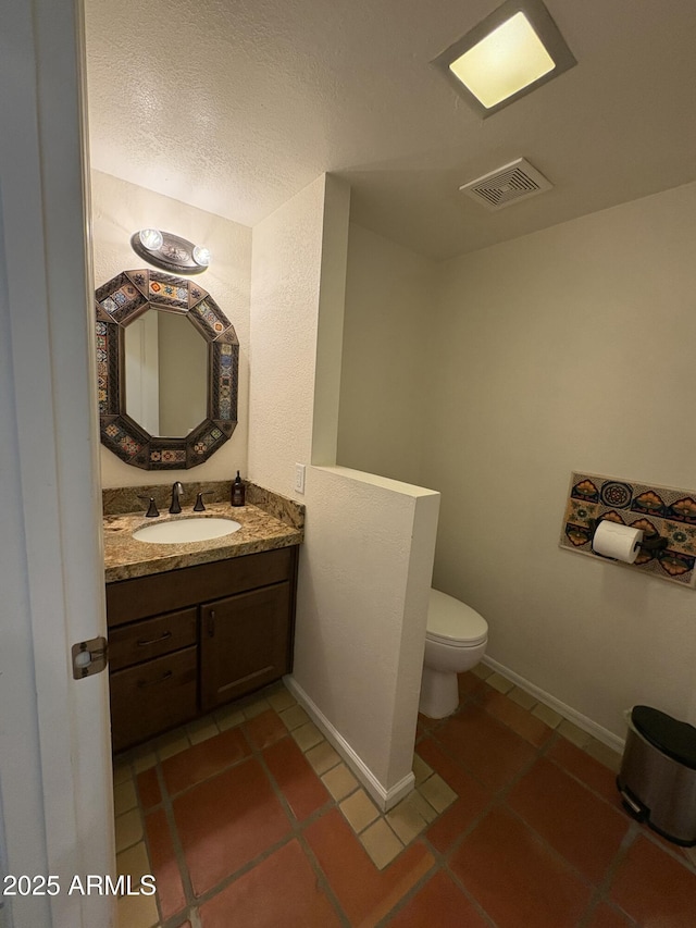 8426 N 15th Dr, Phoenix, AZ 85021 - half bathroom with tile patterned flooring, visible vents, toilet, vanity, and baseboards
