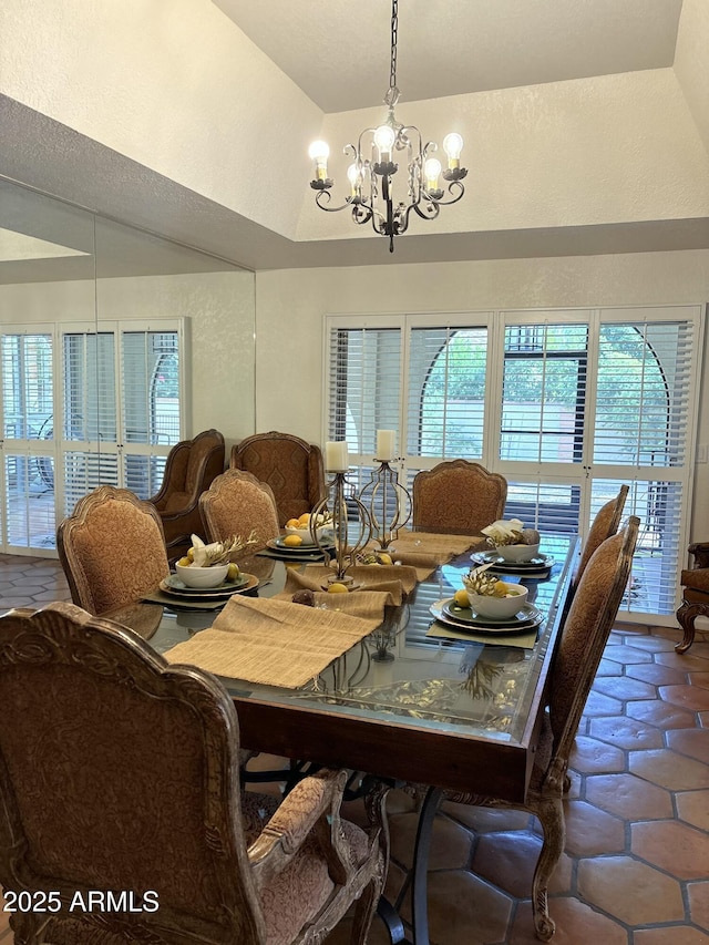 8426 N 15th Dr, Phoenix, AZ 85021 - tiled dining space with an inviting chandelier and high vaulted ceiling