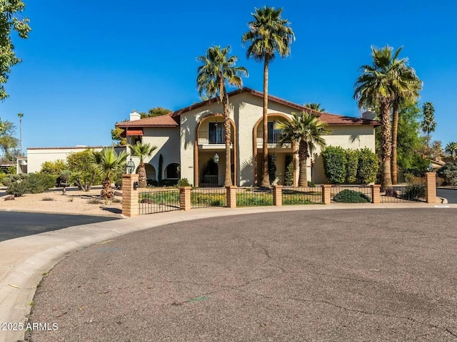 8426 N 15th Dr, Phoenix, AZ 85021 - mediterranean / spanish house featuring stucco siding, a gate, a chimney, and a fenced front yard