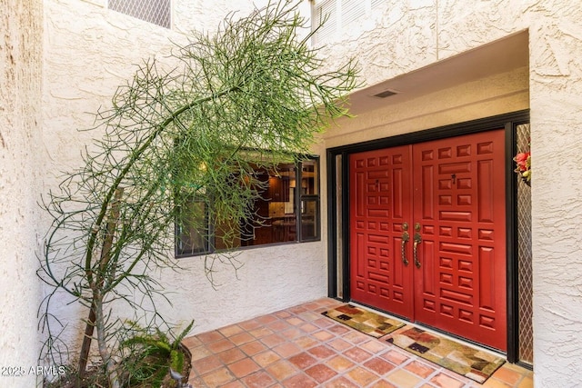 8426 N 15th Dr, Phoenix, AZ 85021 - doorway to property featuring stucco siding and visible vents