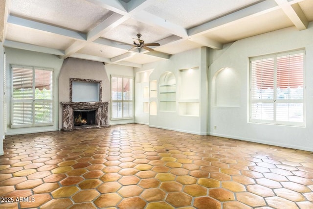 8426 N 15th Dr, Phoenix, AZ 85021 - unfurnished living room featuring beamed ceiling, a lit fireplace, a ceiling fan, and coffered ceiling