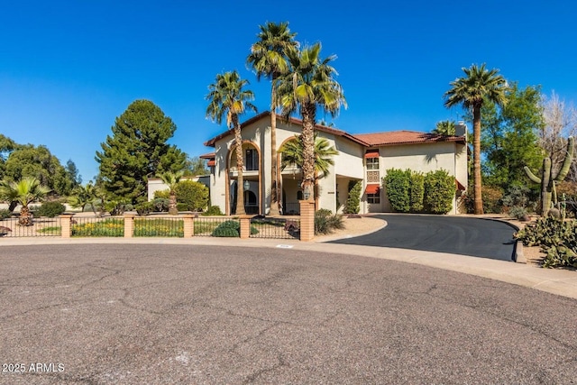 8426 N 15th Dr, Phoenix, AZ 85021 - mediterranean / spanish house featuring curved driveway, stucco siding, and fence