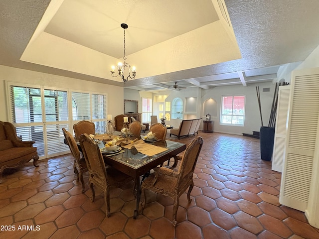 8426 N 15th Dr, Phoenix, AZ 85021 - dining space with beamed ceiling, baseboards, dark tile patterned flooring, a textured ceiling, and ceiling fan with notable chandelier