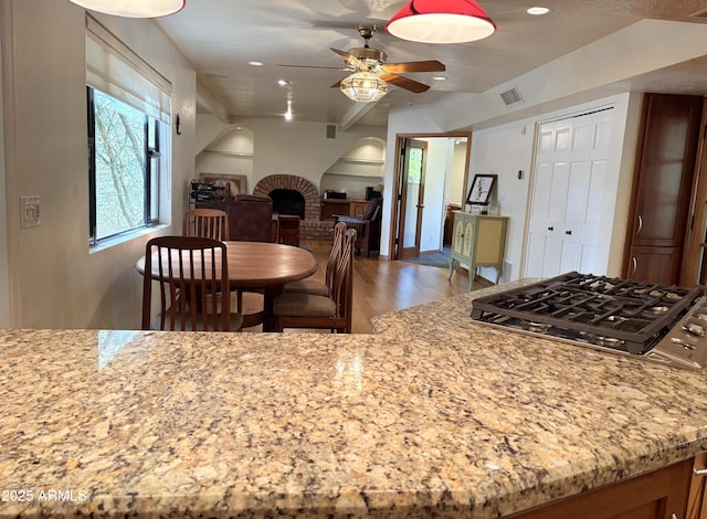 8426 N 15th Dr, Phoenix, AZ 85021 - kitchen featuring a ceiling fan, light stone counters, stainless steel gas stovetop, light wood finished floors, and recessed lighting