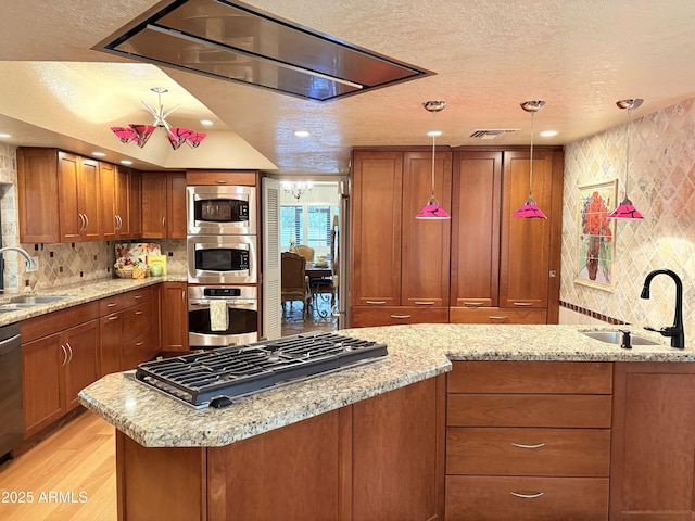8426 N 15th Dr, Phoenix, AZ 85021 - kitchen with brown cabinets, stainless steel appliances, a sink, and a textured ceiling
