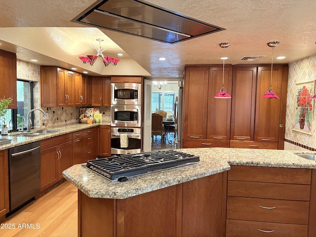 8426 N 15th Dr, Phoenix, AZ 85021 - kitchen featuring brown cabinets, visible vents, a sink, a textured ceiling, and appliances with stainless steel finishes