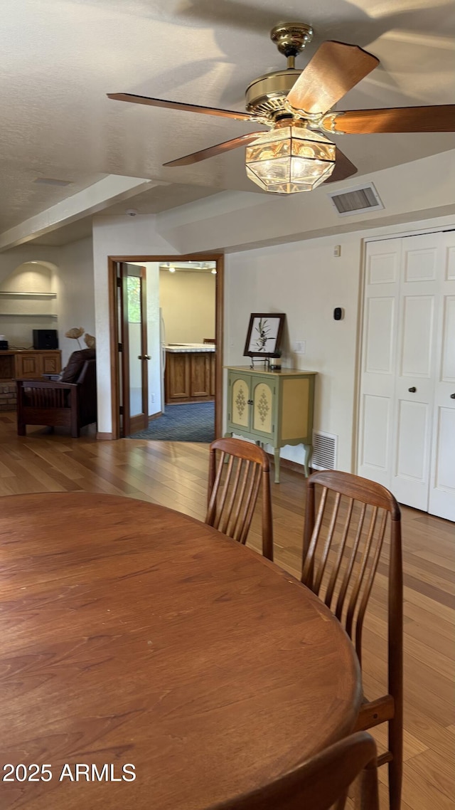8426 N 15th Dr, Phoenix, AZ 85021 - dining space with ceiling fan, wood finished floors, and visible vents