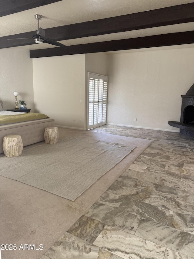 8426 N 15th Dr, Phoenix, AZ 85021 - unfurnished living room featuring baseboards, a wood stove, beam ceiling, and ceiling fan