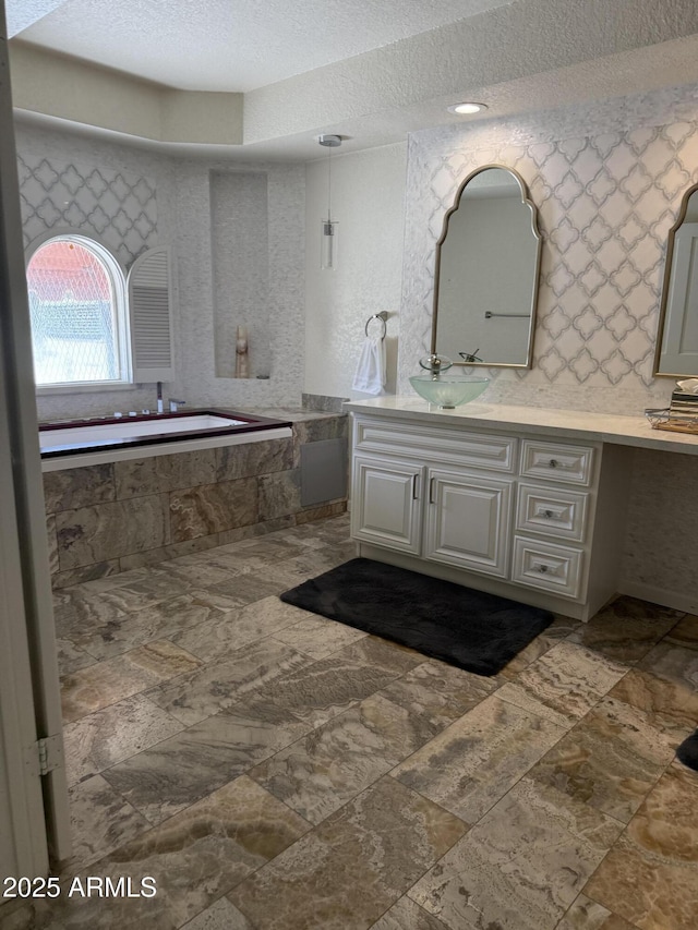 8426 N 15th Dr, Phoenix, AZ 85021 - full bath featuring tiled bath, vanity, and a textured ceiling