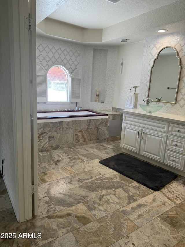8426 N 15th Dr, Phoenix, AZ 85021 - full bath featuring stone finish floor, a textured ceiling, and vanity