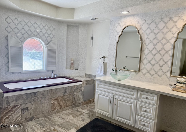8426 N 15th Dr, Phoenix, AZ 85021 - bathroom with a garden tub, vanity, and a textured ceiling