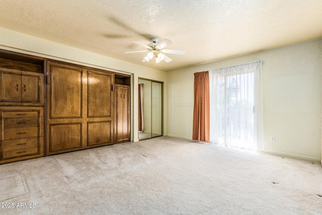 8426 N 15th Dr, Phoenix, AZ 85021 - unfurnished bedroom featuring a textured ceiling, multiple closets, a ceiling fan, and light colored carpet