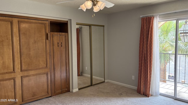 8426 N 15th Dr, Phoenix, AZ 85021 - unfurnished bedroom with light carpet, a textured ceiling, baseboards, access to outside, and multiple closets