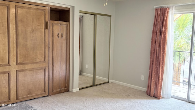 8426 N 15th Dr, Phoenix, AZ 85021 - unfurnished bedroom with light carpet, baseboards, and two closets