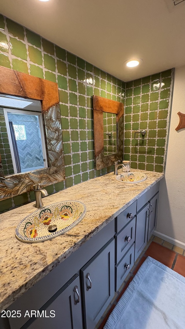 8426 N 15th Dr, Phoenix, AZ 85021 - bathroom with double vanity, tile patterned floors, baseboards, and a sink