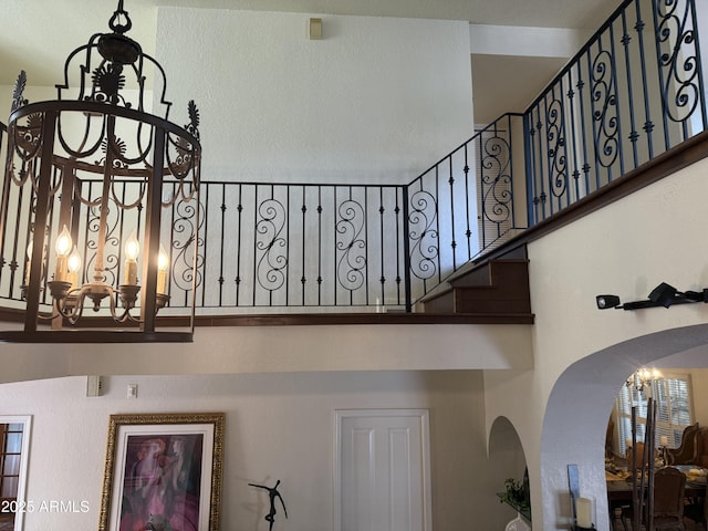 8426 N 15th Dr, Phoenix, AZ 85021 - stairs featuring a high ceiling, arched walkways, and a chandelier