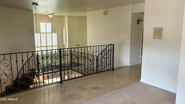 8426 N 15th Dr, Phoenix, AZ 85021 - hallway featuring tile patterned floors, an upstairs landing, baseboards, a textured ceiling, and carpet flooring