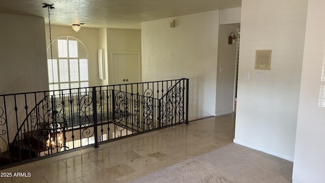 8426 N 15th Dr, Phoenix, AZ 85021 - corridor featuring a textured ceiling, tile patterned floors, and an upstairs landing