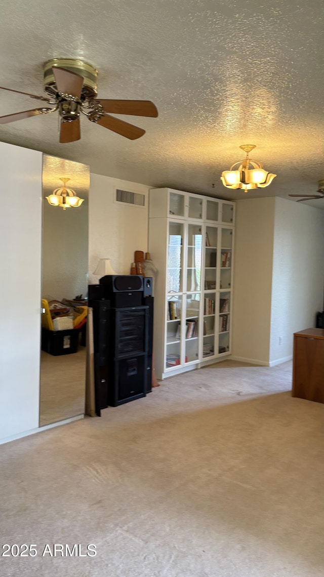 8426 N 15th Dr, Phoenix, AZ 85021 - carpeted living area featuring a textured ceiling, visible vents, and ceiling fan