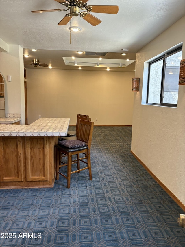 8426 N 15th Dr, Phoenix, AZ 85021 - interior space featuring dark carpet, baseboards, a ceiling fan, and visible vents