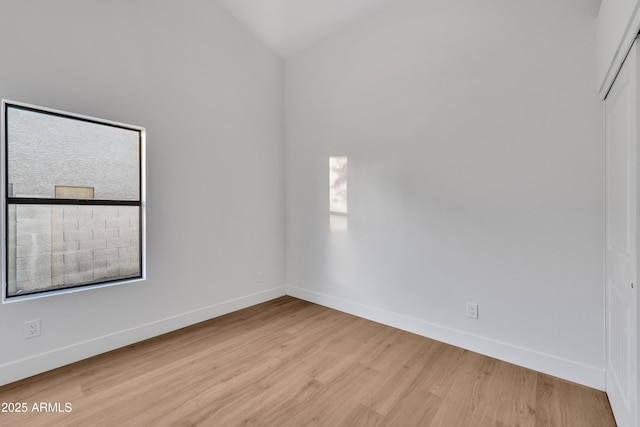 1001 N Nielson St, Gilbert, AZ 85234 - spare room with light wood-style flooring, baseboards, and vaulted ceiling