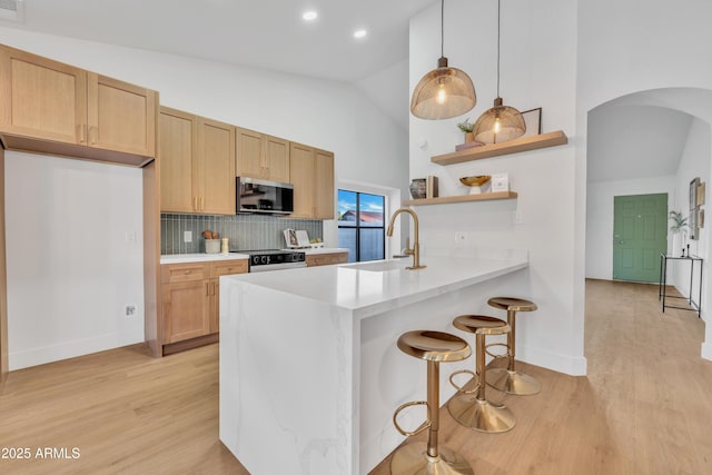 1001 N Nielson St, Gilbert, AZ 85234 - kitchen with stainless steel microwave, a sink, arched walkways, open shelves, and electric range oven