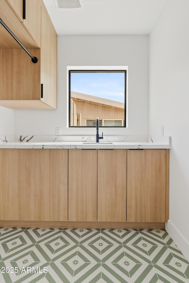 bathroom with sink and tile patterned flooring