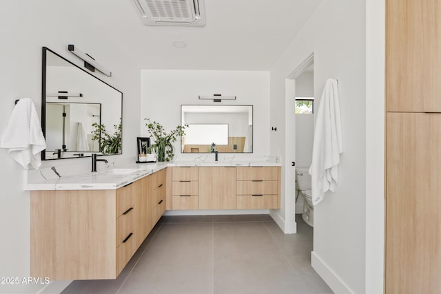 bathroom with tile patterned floors, vanity, and toilet