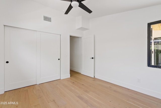 unfurnished bedroom featuring light wood-type flooring and ceiling fan