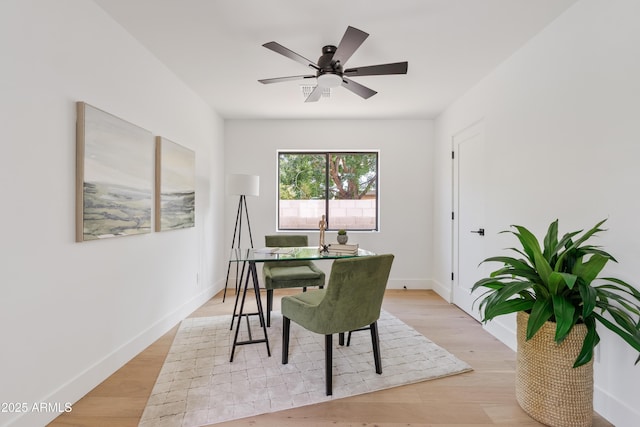 dining area with ceiling fan and light wood-type flooring