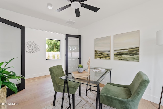 dining space with ceiling fan and light hardwood / wood-style flooring