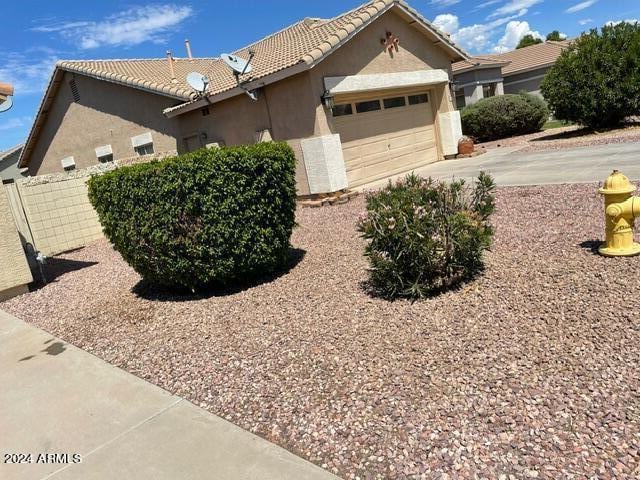 view of side of home featuring a garage