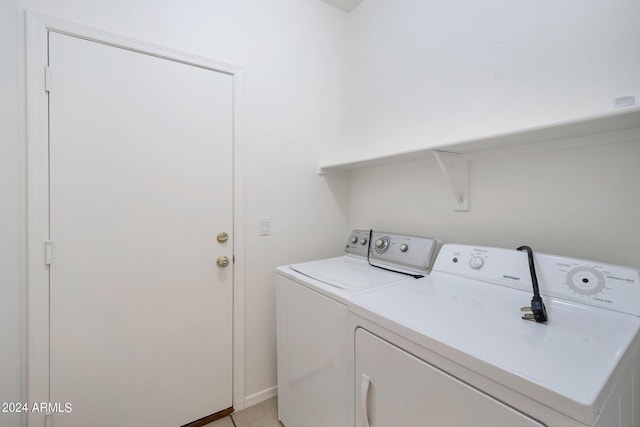 washroom with washing machine and clothes dryer