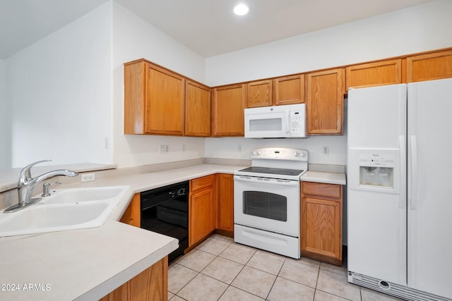 kitchen featuring white appliances, sink, and light tile patterned floors