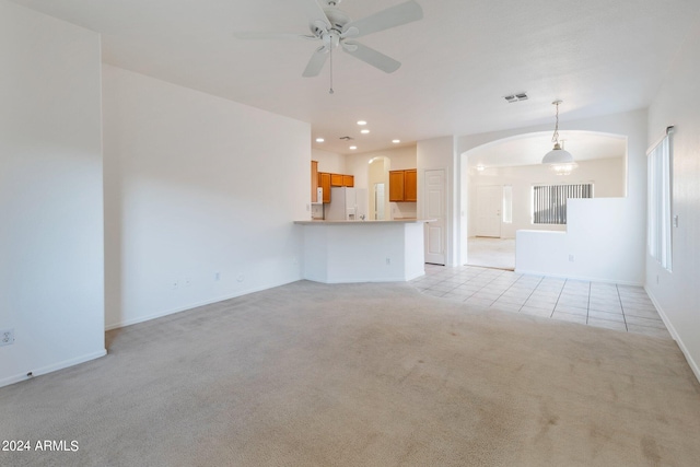 unfurnished living room with light tile patterned floors and ceiling fan