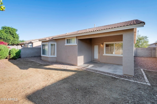 back of property with a patio area