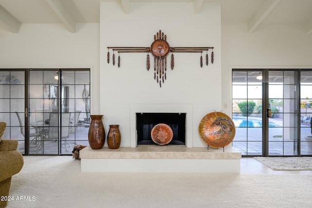 living room with beam ceiling and light carpet