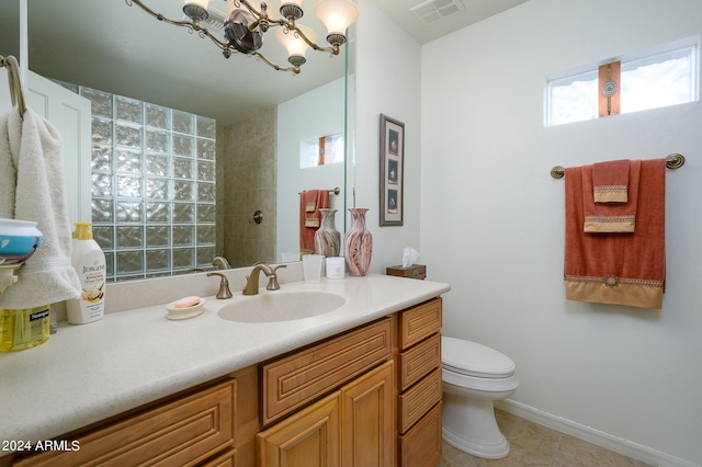 bathroom with toilet, tile floors, a notable chandelier, and large vanity