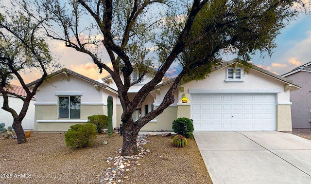 ranch-style house featuring driveway, an attached garage, and stucco siding