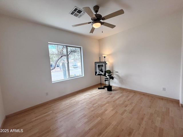 unfurnished room with light wood-style floors, visible vents, ceiling fan, and baseboards