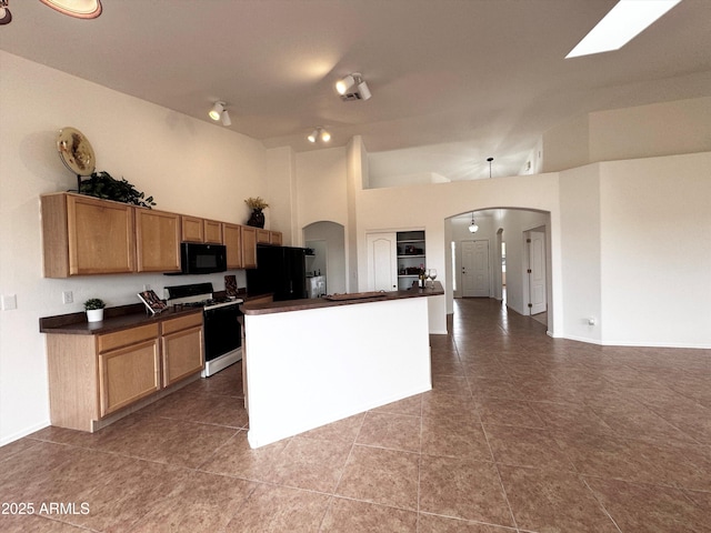 kitchen with arched walkways, high vaulted ceiling, tile patterned flooring, black appliances, and dark countertops