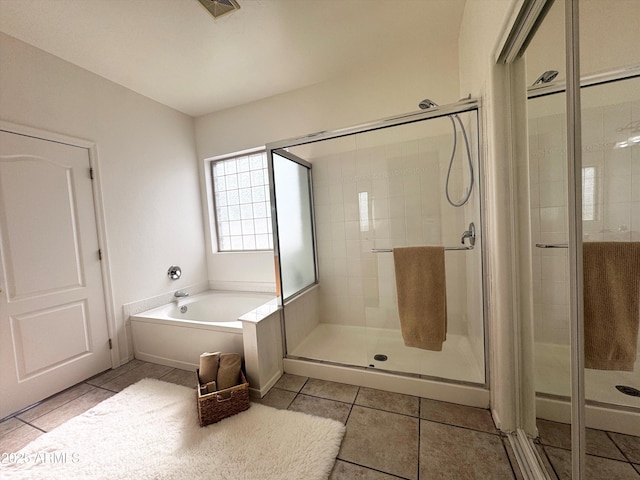 bathroom featuring tile patterned flooring, visible vents, a garden tub, and a shower stall