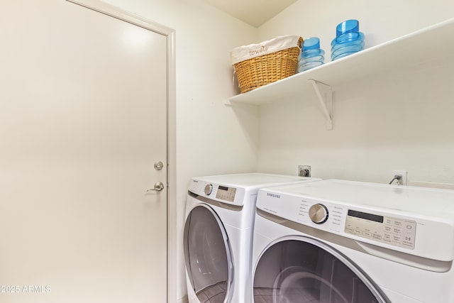 washroom featuring washing machine and dryer and tile patterned flooring