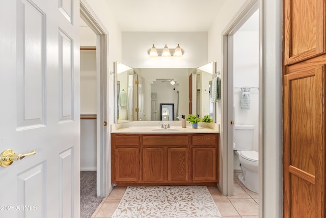 bathroom with tile patterned flooring, toilet, and vanity