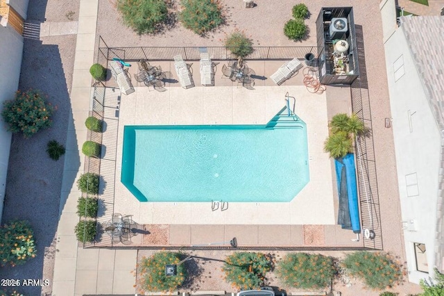 view of subject property with a pool