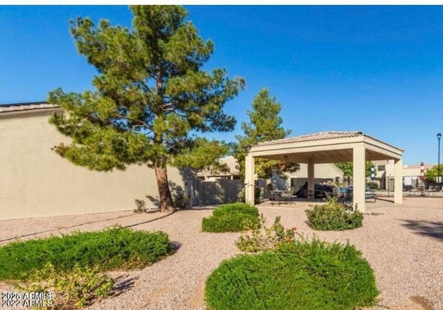 view of property's community with a gazebo and fence