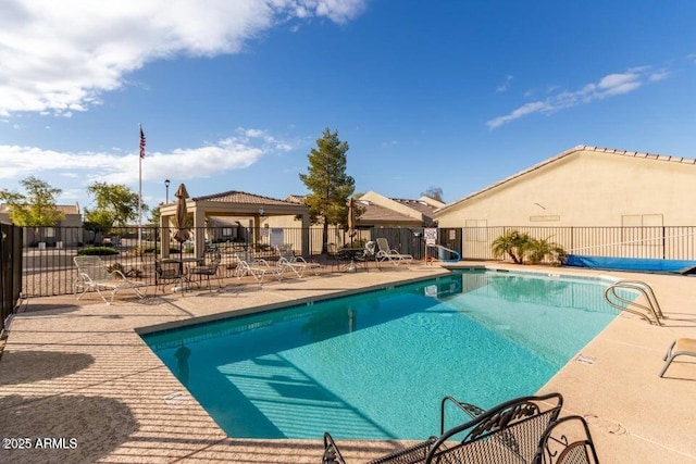 community pool featuring fence and a patio area