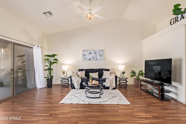 living area featuring a ceiling fan, wood finished floors, high vaulted ceiling, and baseboards
