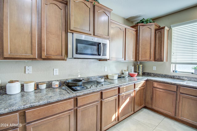 kitchen with light tile patterned floors and appliances with stainless steel finishes