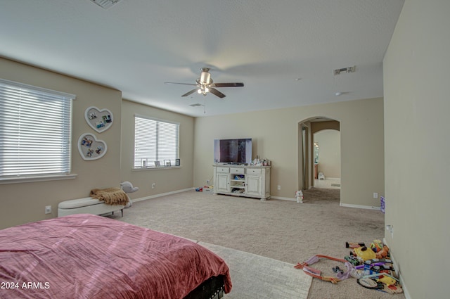 bedroom with ceiling fan and light colored carpet